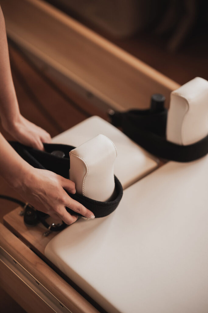 Hands on a Pilates machine Club Health, Chelsea